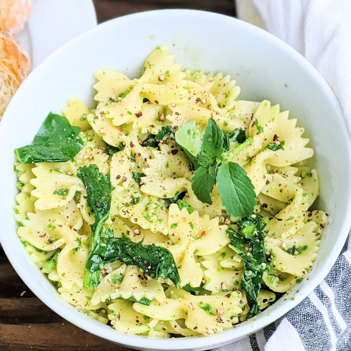 no salt pesto sauce low sodium pesto without salt but has pine nuts pignoles fresh italian genovese basil over pasta in a bowl.