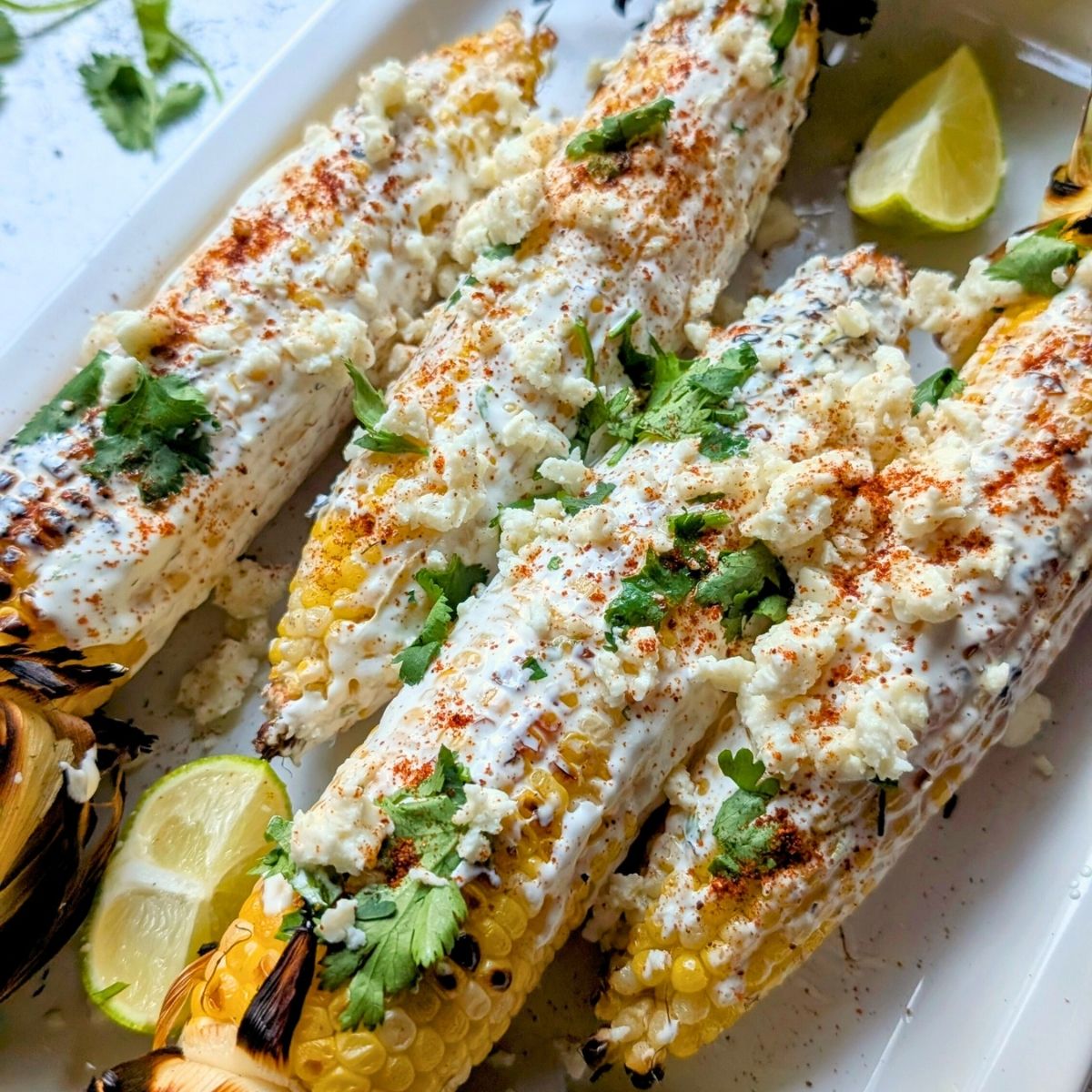 low sodium corn recipe with cheese, fresh herbs, and sour cream on a plate.